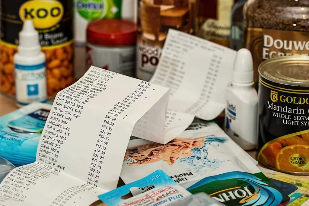 picture of pantry items on table with grocery store receipt 