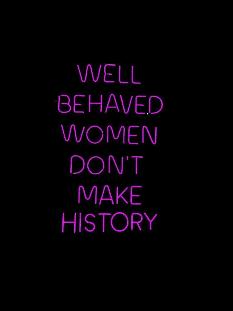 neon light with quote "well behaved women don't make history"