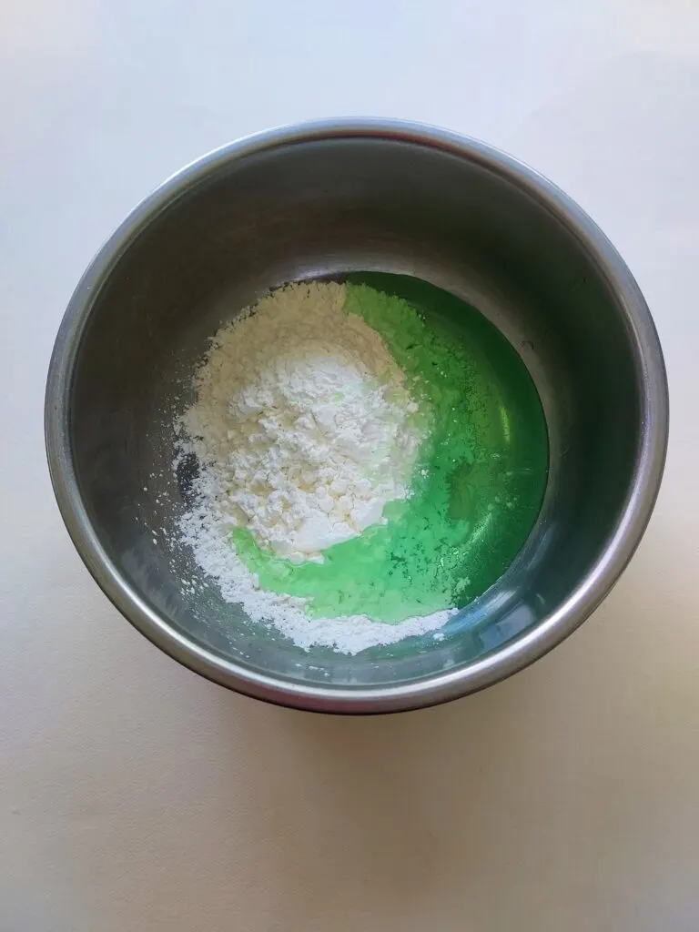 metal bowl with cornstarch and green shampoo