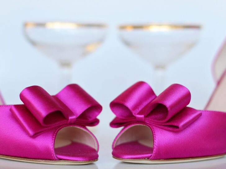 hot pink satin open toe shoes with bows. gold rimmed martini glasses in background Barbiecore Barbie Party