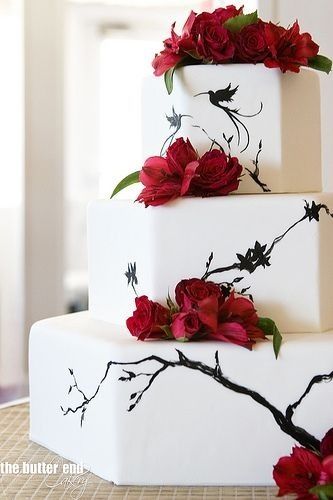 Wedding cake with black branches and red roses