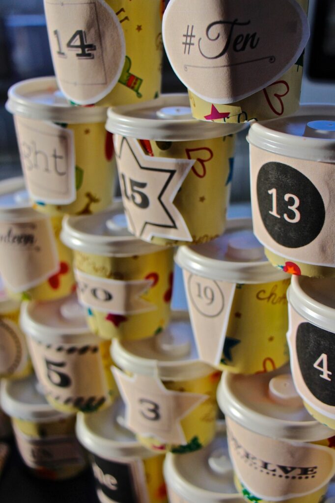 covered cups labeled with numbers for advent calendar