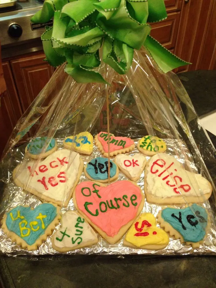 basket of cookies decorated with various positive, yes statements in response to a promposal
