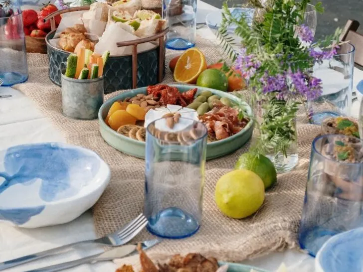 table decorated with place settings, flowers, fruit, cheese, nut platter, Brunch Ideas That&rsquo;ll Make You the MVP of Mid-Morning Meals