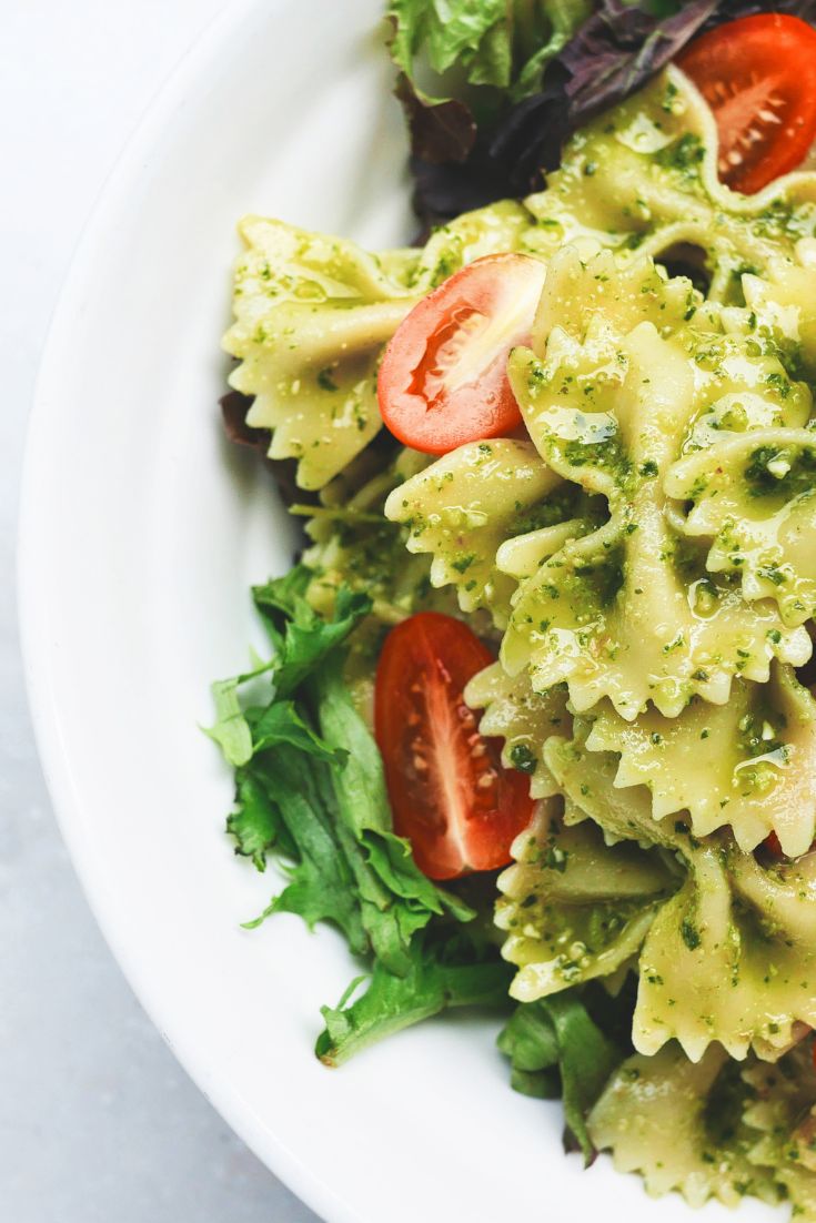 bowtie pasta, cherry tomatoes, red and green romaine lettuce, pesto sauce. summer salad ideas