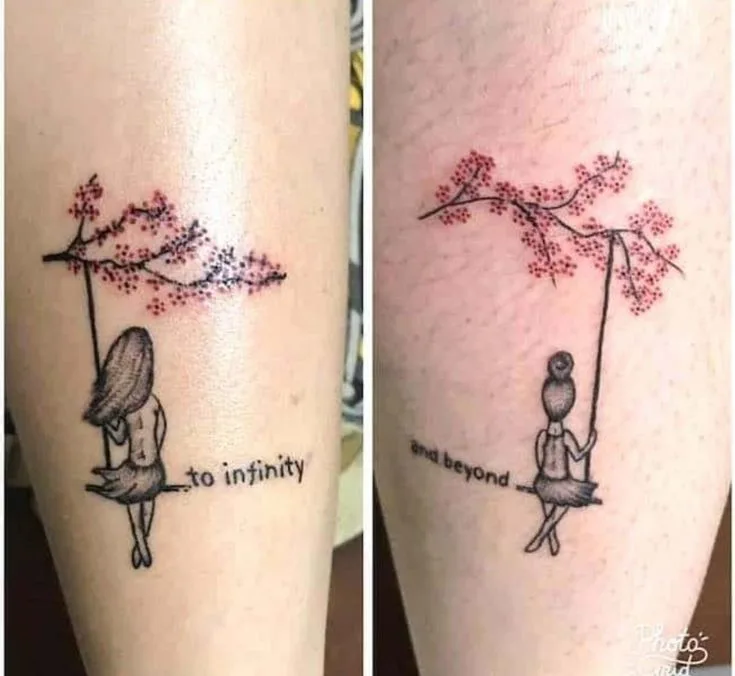 matching tattoos - cherry tree branch and flowers, swing with girl, one girl long hair, one girl hair in bun, to infinity on one person, and beyond on the other